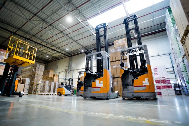 two-lift-trucks-parked-on-alley-in-huge-warehouse-2021-08-29-22-34-38-utc-scaled.jpg